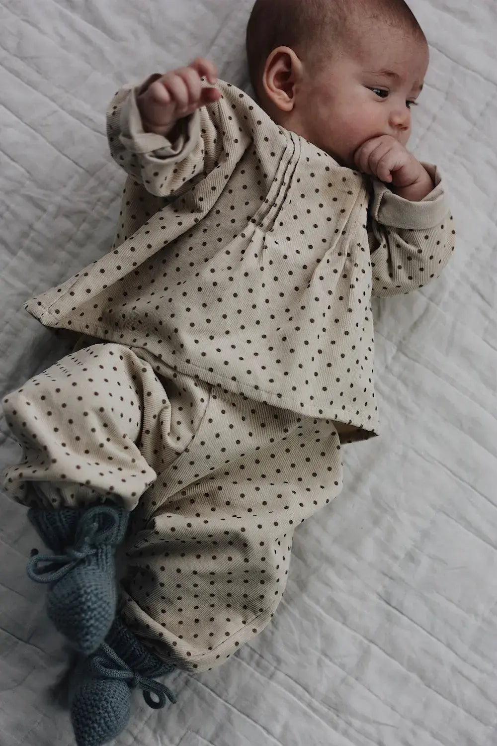 Baby wearing Lalaby knitted Alpha shoes for babies in dove blue cashmere