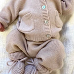 Baby wearing full Lalaby outfit in powder pink cashmere, including a Bobbie cardigan, stormy pants and alpha shoes