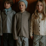 Boy wearing Lalaby Andy hoodie for kids in a millet brown baby wool, yak and cashnere blend
