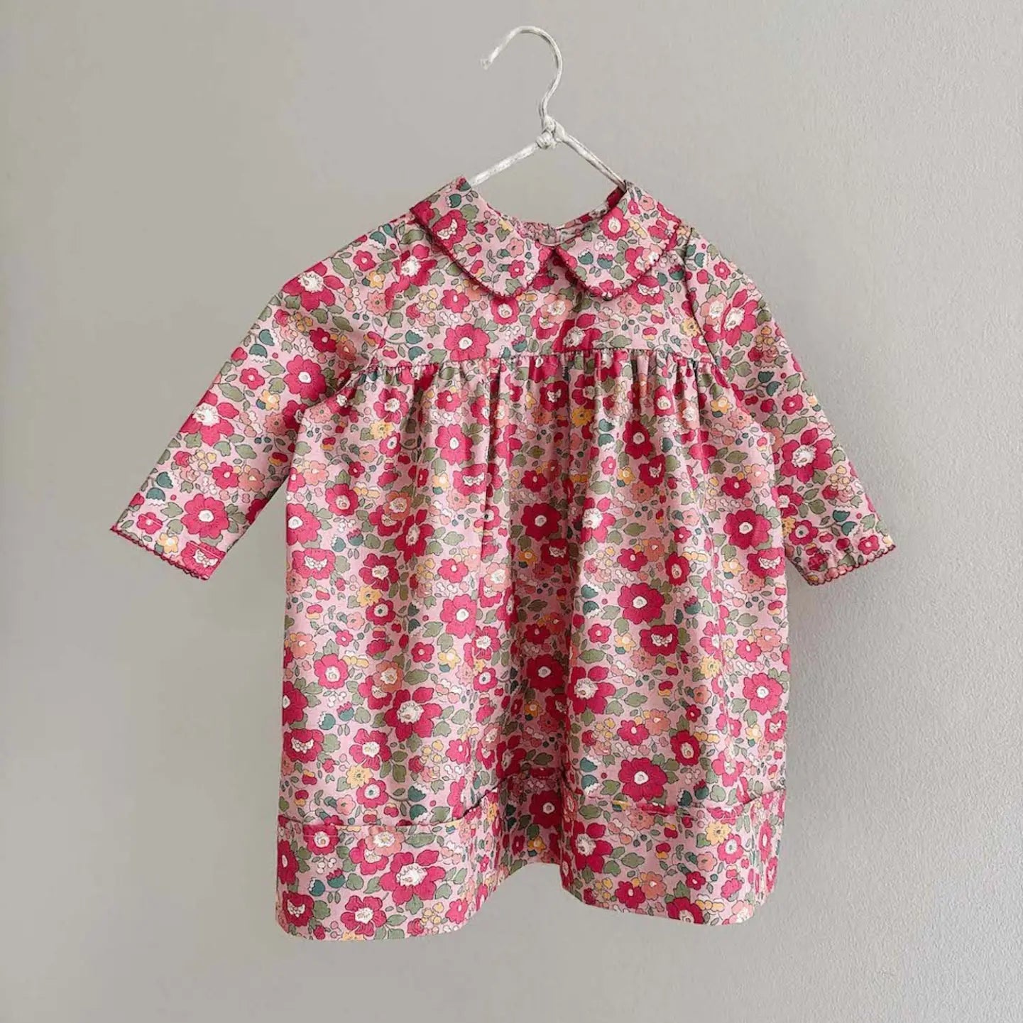 Lalaby Anna dress for babies in berry betsy pink liberty organic cotton
