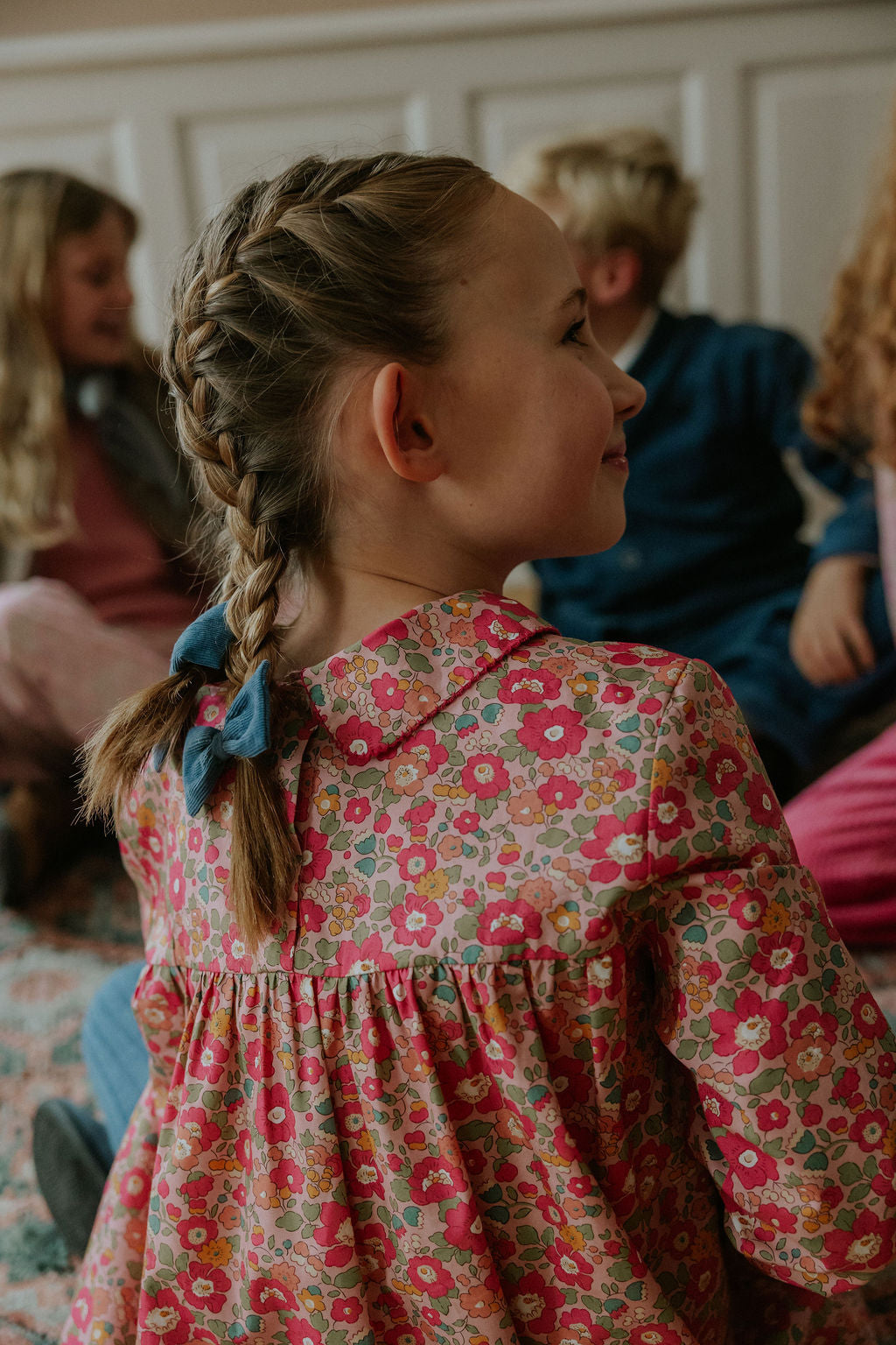 Girl wearing Lalaby Anna dress for kids in berry betsy pink liberty organic cotton