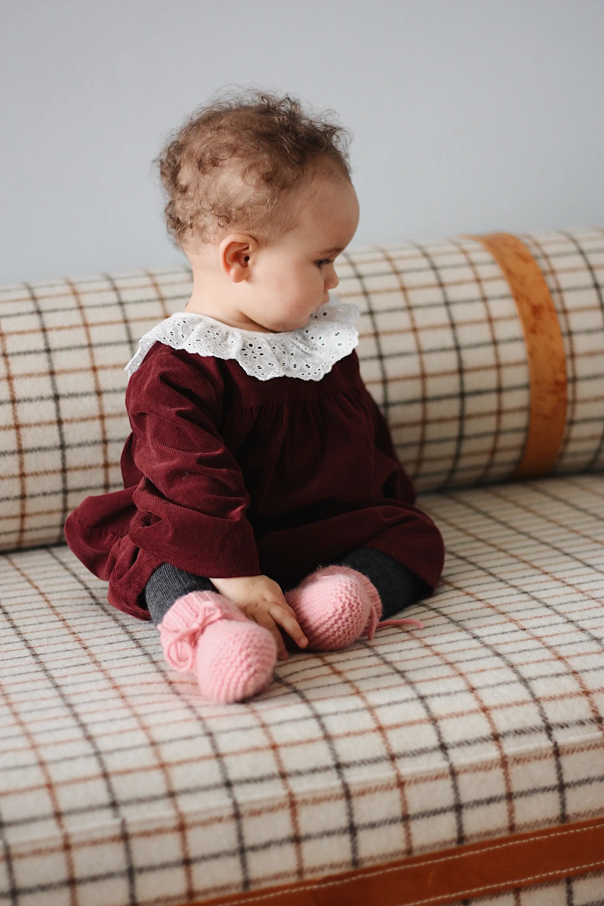 Baby girl wearing Lalaby Annabella baby dress in ruby red cotton baby corduroy