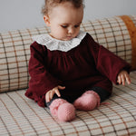 Baby girl wearing Lalaby Annabella dress for babies in ruby red cotton baby cord