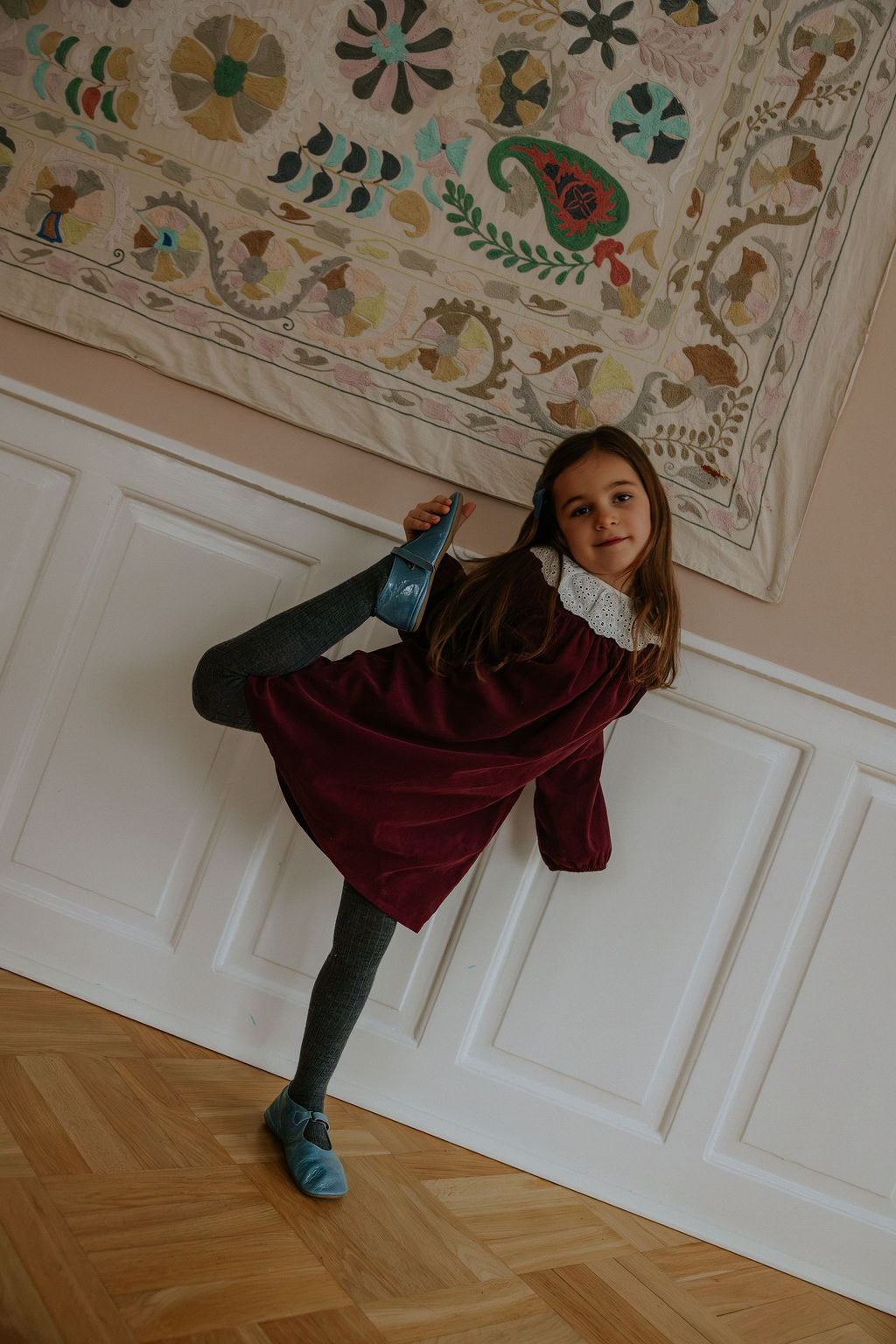Girl wearing Lalaby Annabella dress for kids in ruby red cotton baby cord