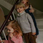 Boy wearing Lalaby Atlas scarf in bluey light blue cashmere