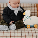 Baby boy wearing Lalaby knitted Alpha shoe and Altas scarf in bluey light blue cashmere
