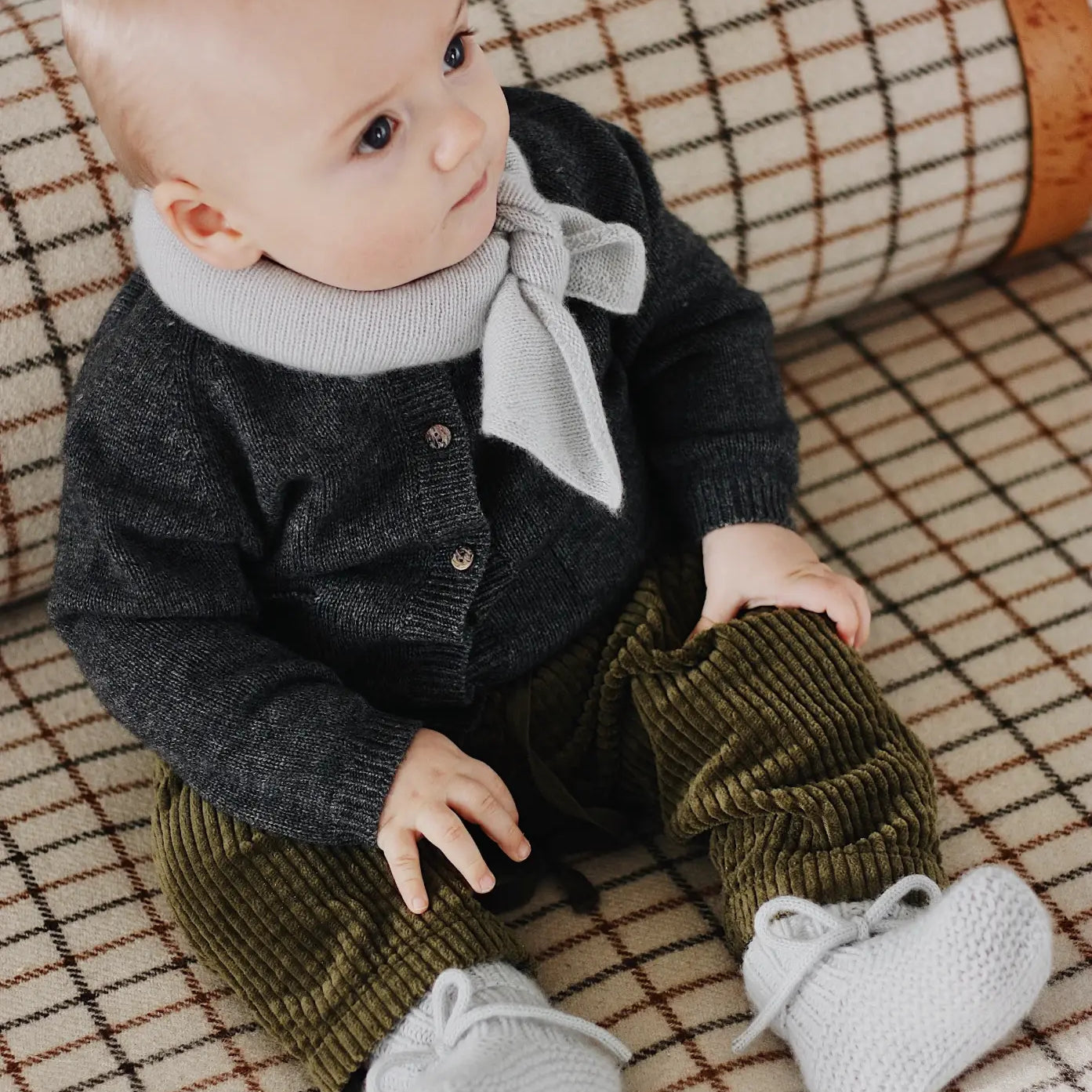 Baby boy wearing Lalaby knitted Alpha shoe and Altas scarf in bluey light blue cashmere