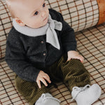 Baby boy wearing Lalaby knitted Alpha shoe and Altas scarf in bluey light blue cashmere