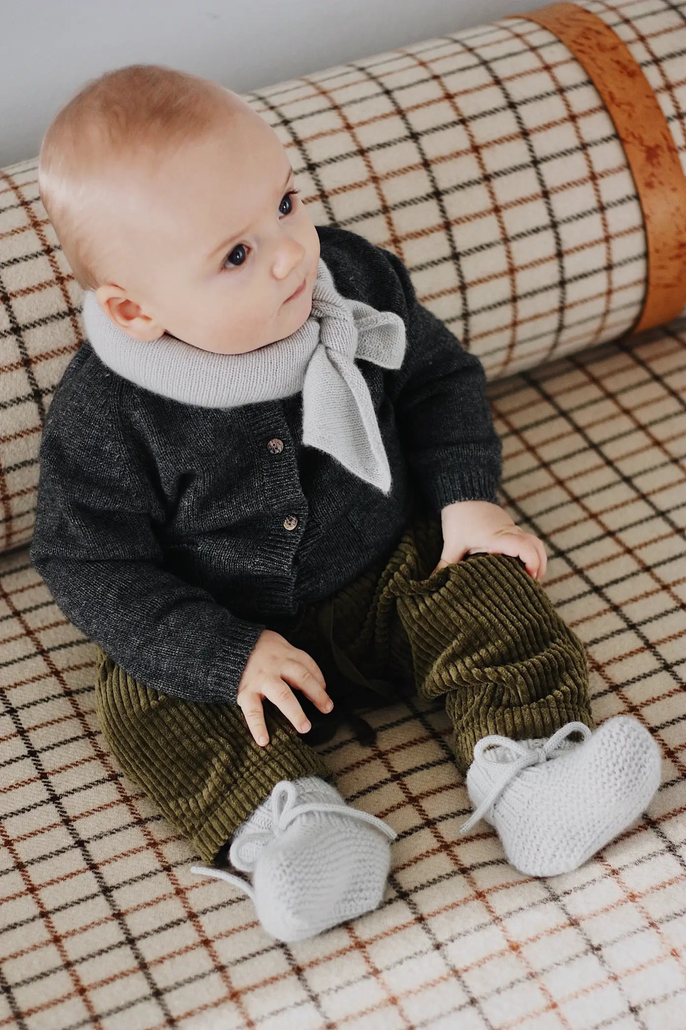 Baby boy wearing Lalaby knitted Alpha shoe and Altas scarf in bluey light blue cashmere