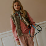 Girl wearing Lalaby Atlas scarf in dove blue cashmere