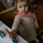 Girl wearing Lalaby Atlas scarf in sorbet pink cashmere