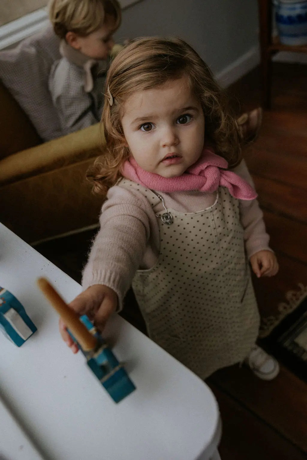 Girl wearing Lalaby Atlas scarf in sorbet pink cashmere