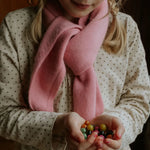 Girl wearing Lalaby Atlas scarf big in sorbet pink cashmere