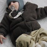 Baby boy wearing Lalaby Babar jacket for babies in chocolate brown merino wool