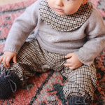 Baby boy wearing tweedy check organic cotton bib from Lalaby Bibi bib 2-pack