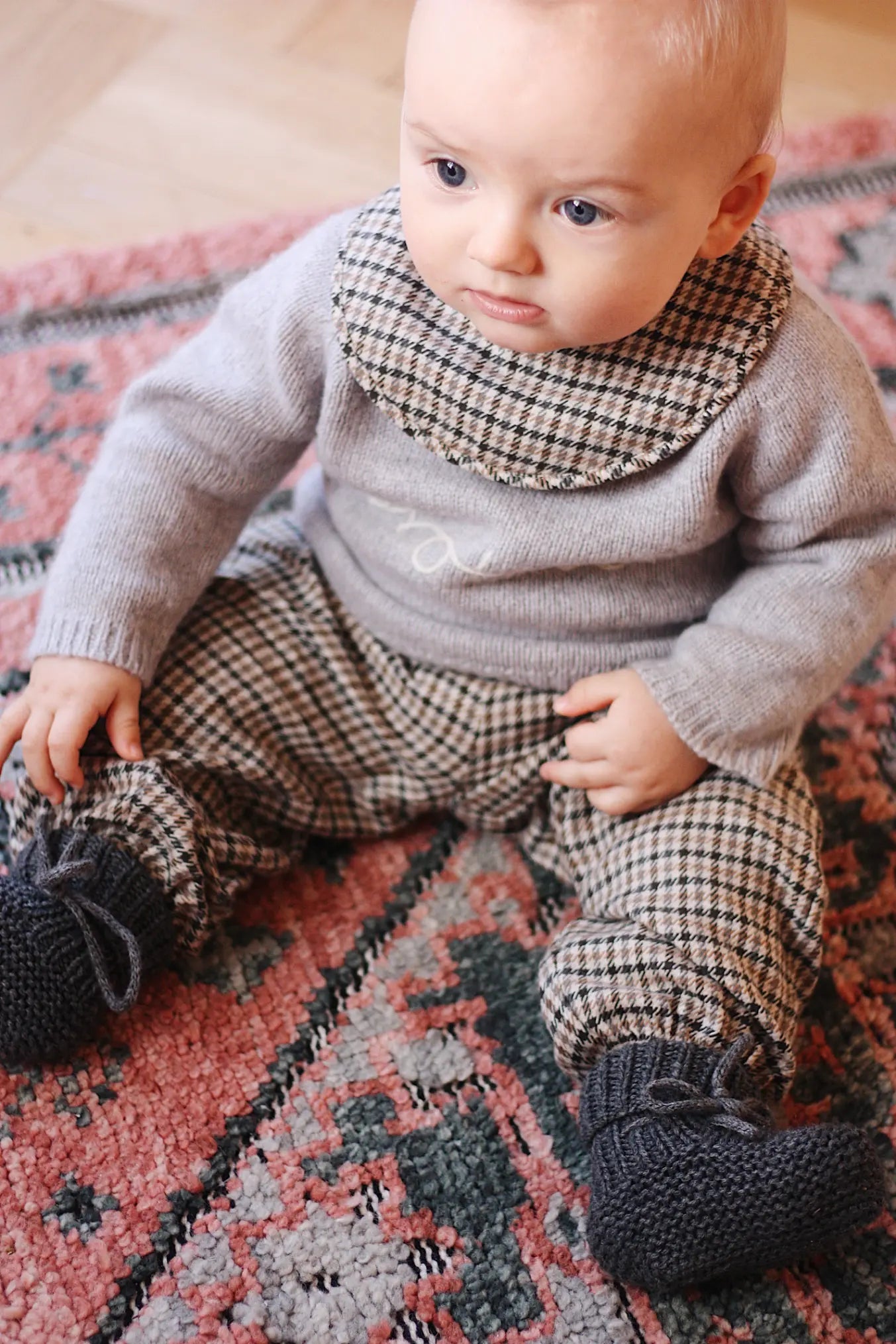 Baby boy wearing tweedy check organic cotton bib from Lalaby Bibi bib 2-pack