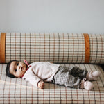 Baby girl wearing Lalaby Bobbie baby cardigan in powder pink cashmere