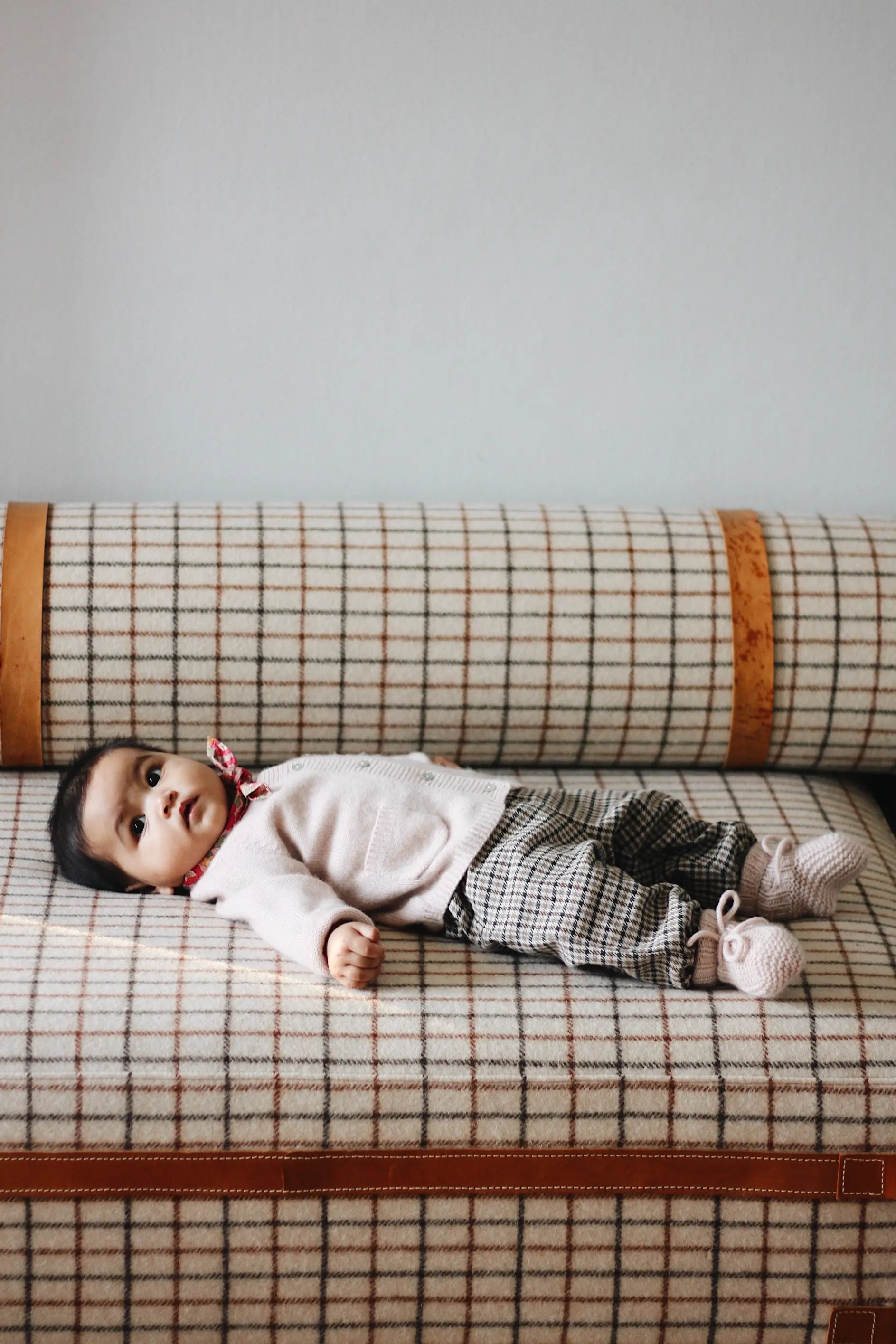 Baby girl wearing Lalaby Bobbie baby cardigan in powder pink cashmere