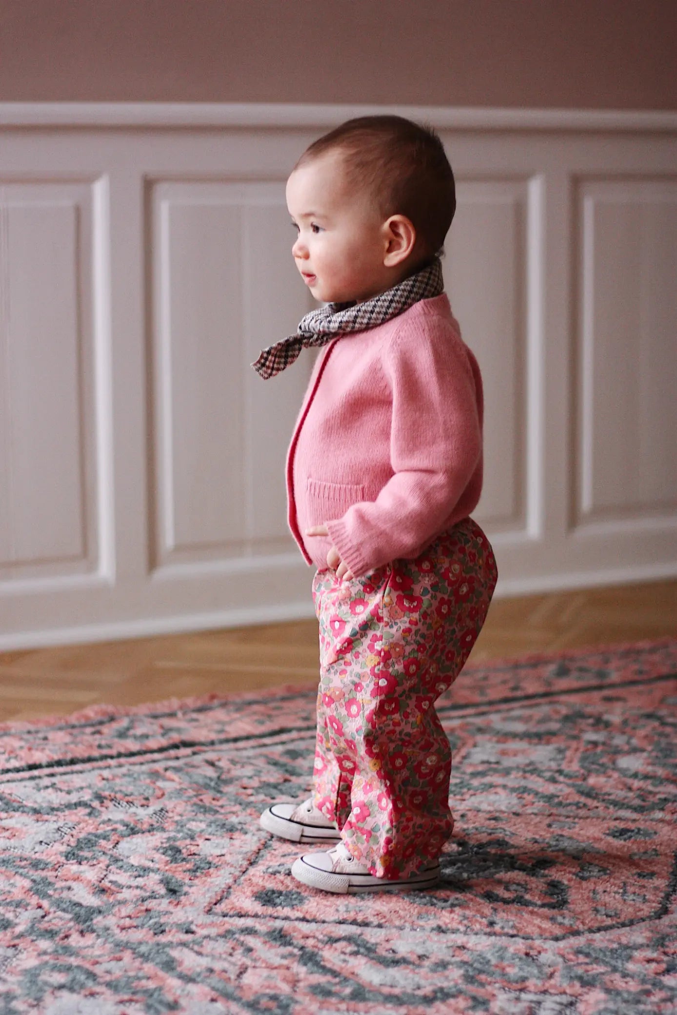 Baby girl wearing Lalaby Bobbie baby cardigan in sorbet pink cashmere