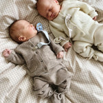 Baby wearing Lalaby knitted Alpha shoes, Bobbie cardigan and Stormy pants in toast brown cashmere