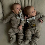 Twins wearing Lalaby knitted Alpha shoes, Bobbie cardigan and Stormy pants for babies in toast brown cashmere