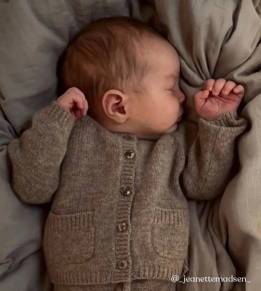 Baby wearing Lalaby Bobbie cardigan in toast brown cashmere