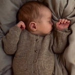 Baby wearing Lalaby Bobbie cardigan in toast brown cashmere