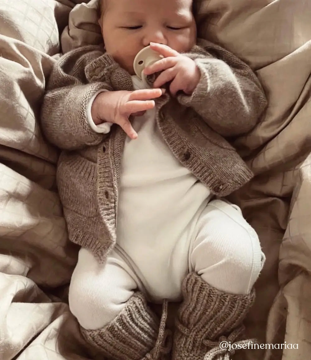 Baby wearing Lalaby knitted Alpha shoes and Bobbie cardigan in toast brown cashmere