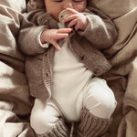 Baby wearing Lalaby knitted Alpha shoes and Bobbie cardigan in toast brown cashmere