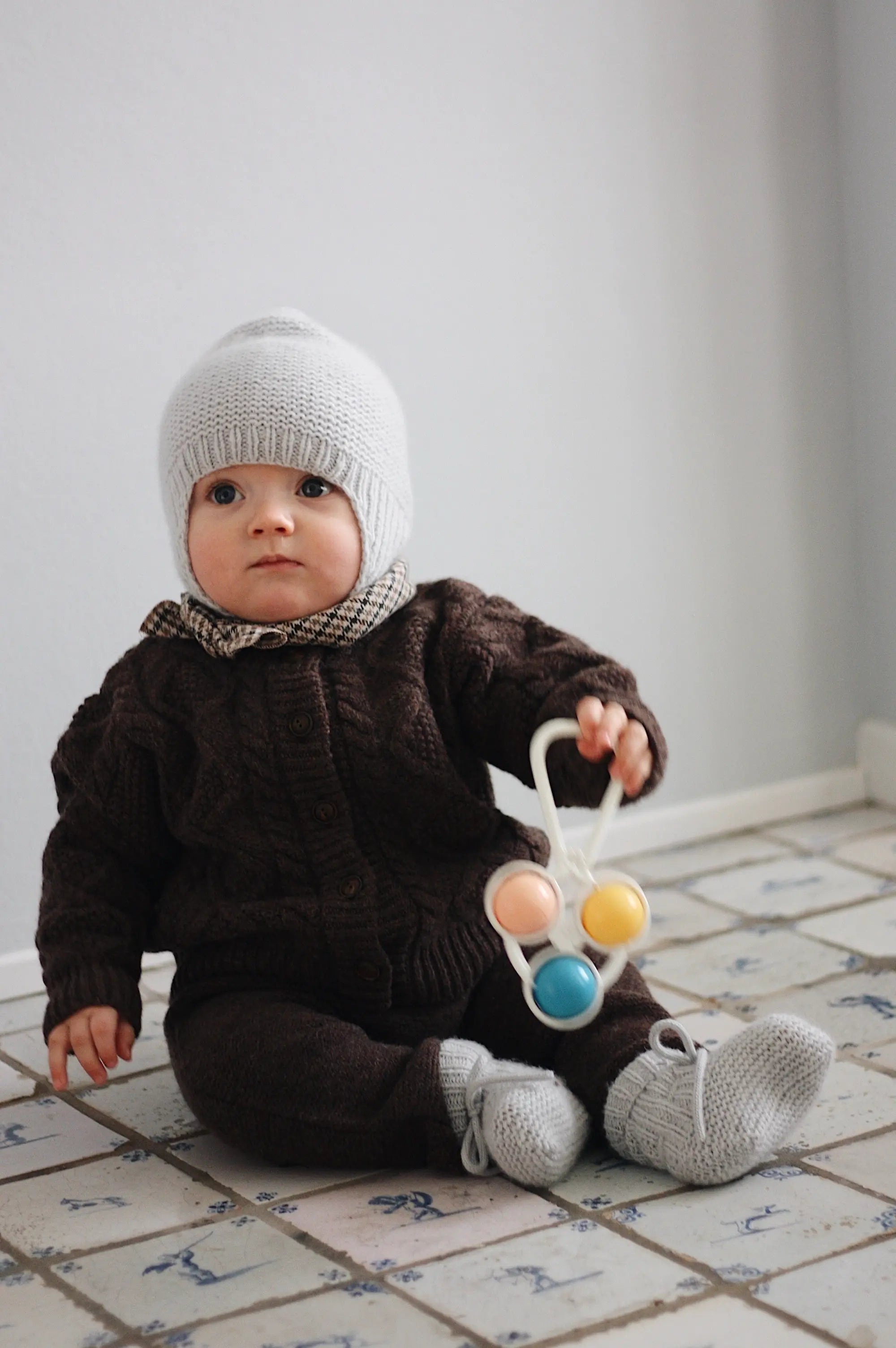 Baby boy wearing Lalaby knitted Bobo hat and Alpha shoes in bluey light blue cashmere