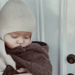 Baby wearing a Lalaby Bobo hat in powder pink cashmere