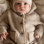 Baby wearing a Lalaby Bobo hat in powder pink cashmere