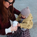 Baby wearing Lalaby knitted Bobo hat in toast brown cashmere