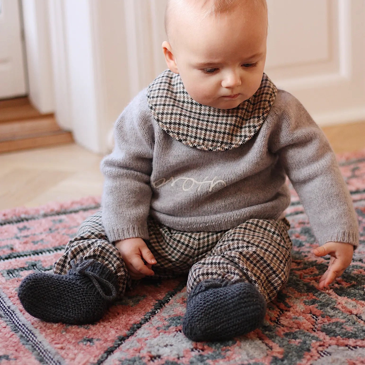 Baby boy wearing Lalaby Brother baby sweater in a grey baby wool, yak and cashmere blend