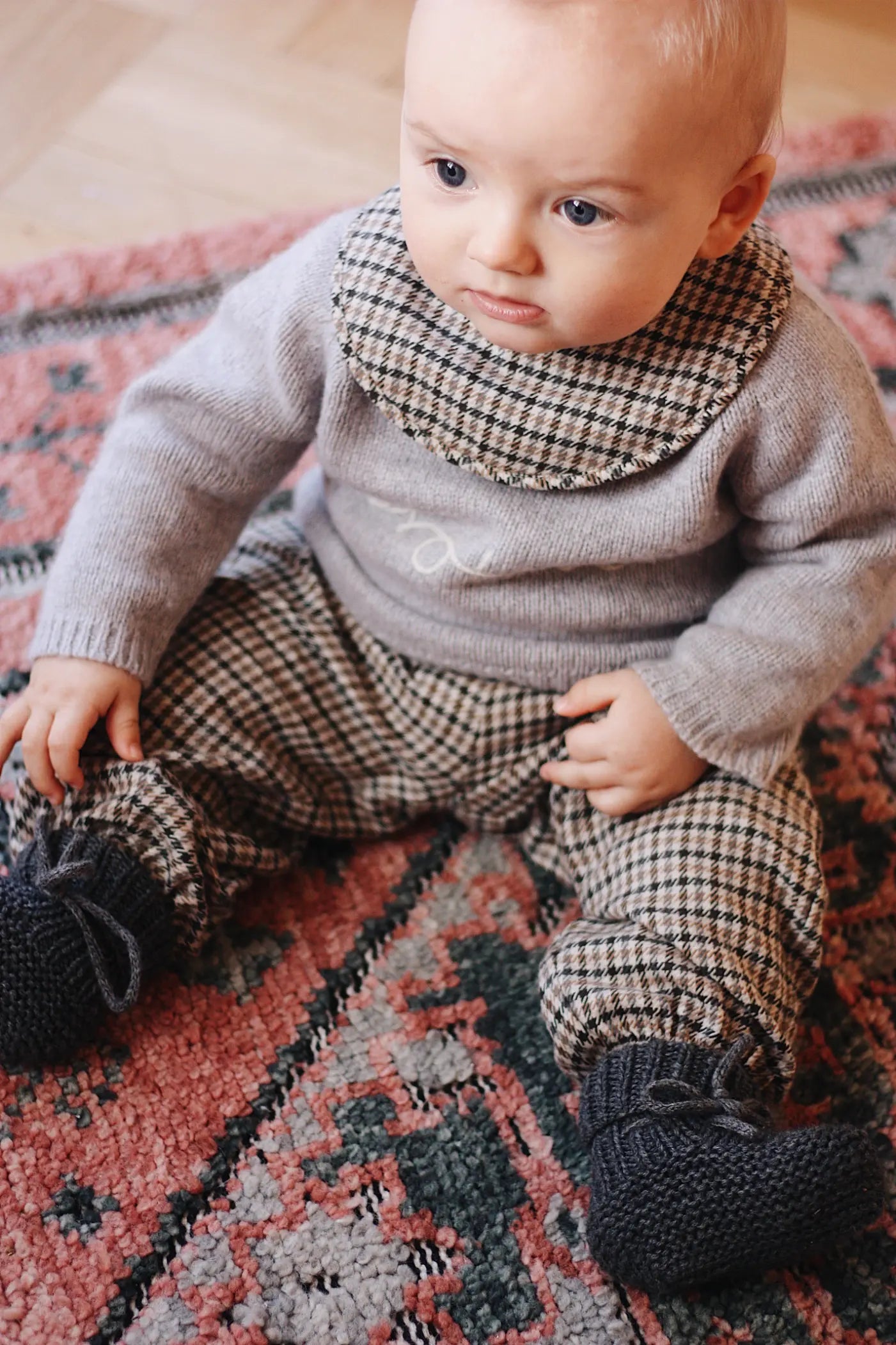 Baby boy wearing Lalaby Brother baby sweater in a grey baby wool, yak and cashmere blend