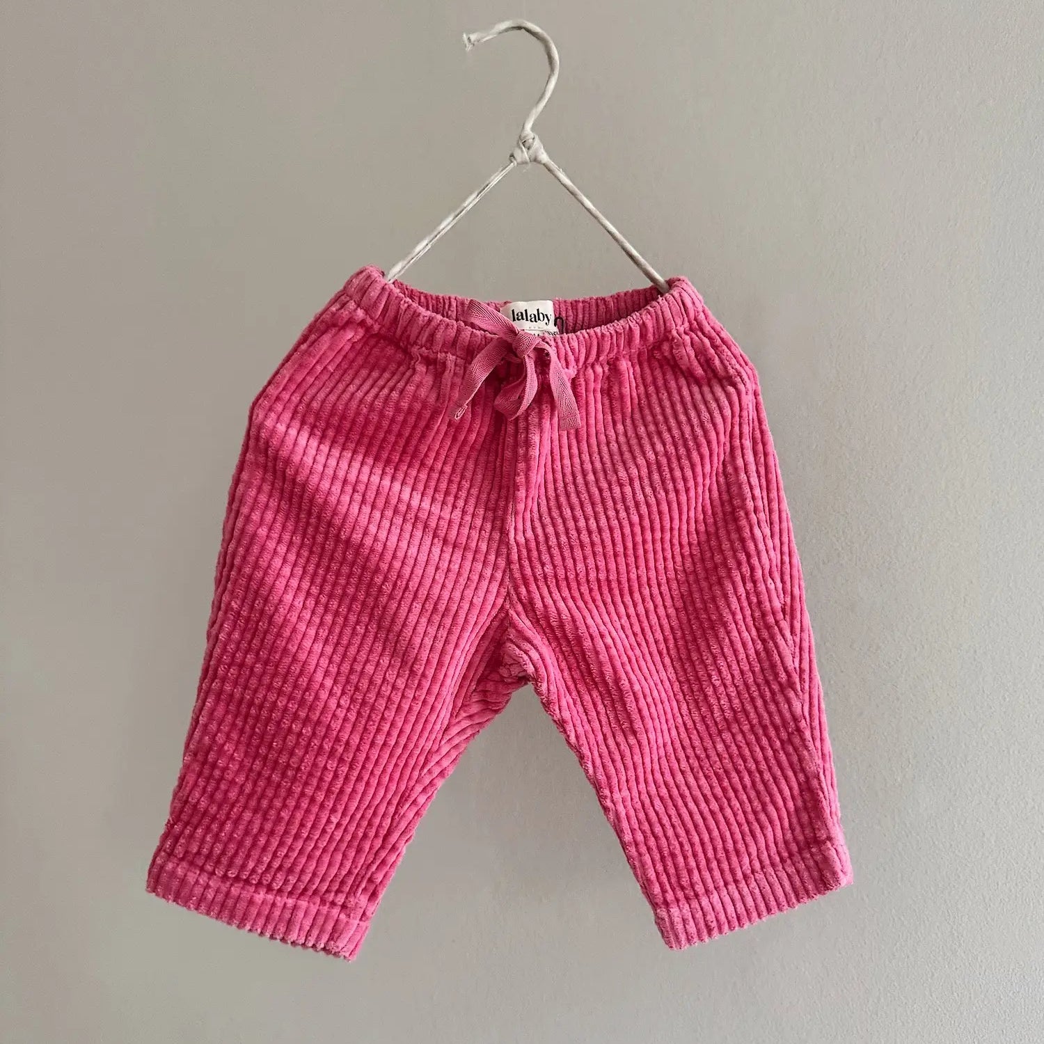 Lalaby Charlie trousers for babies in flamingo pink organic cotton mega cord
