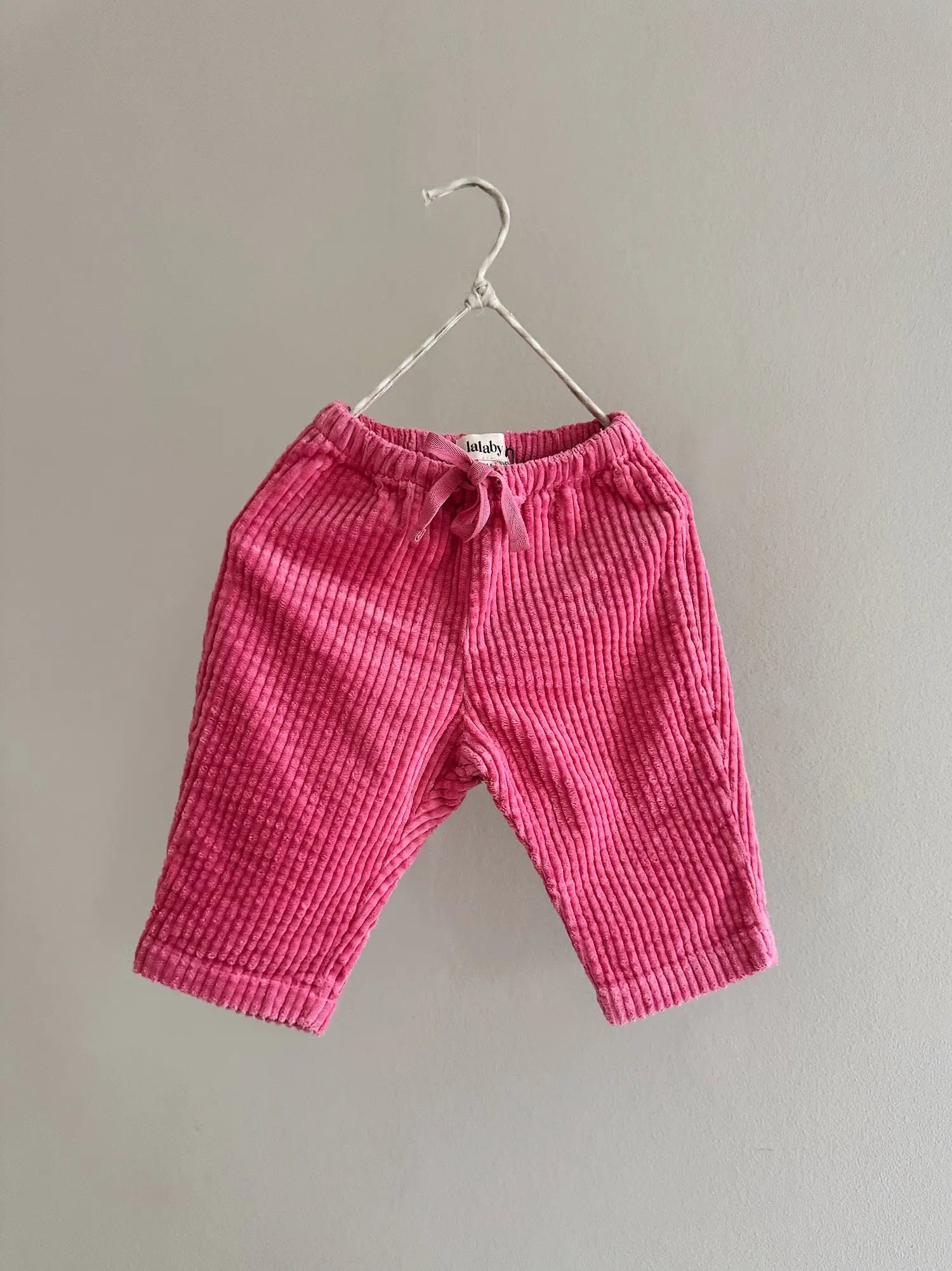 Lalaby Charlie trousers for babies in flamingo pink organic cotton mega cord