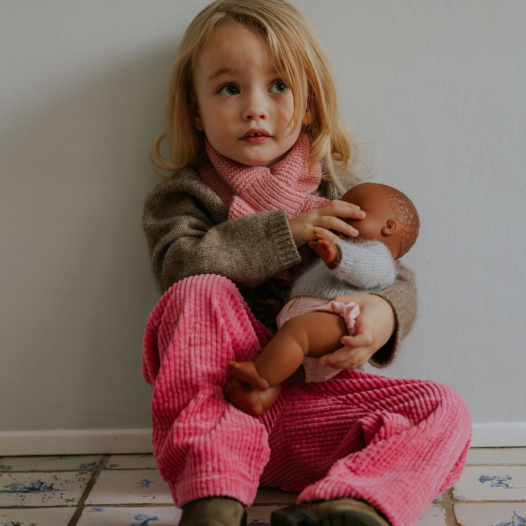 Girl wearing Lalaby Charlie trousers for kids in flamingo pink organic cotton mega cord