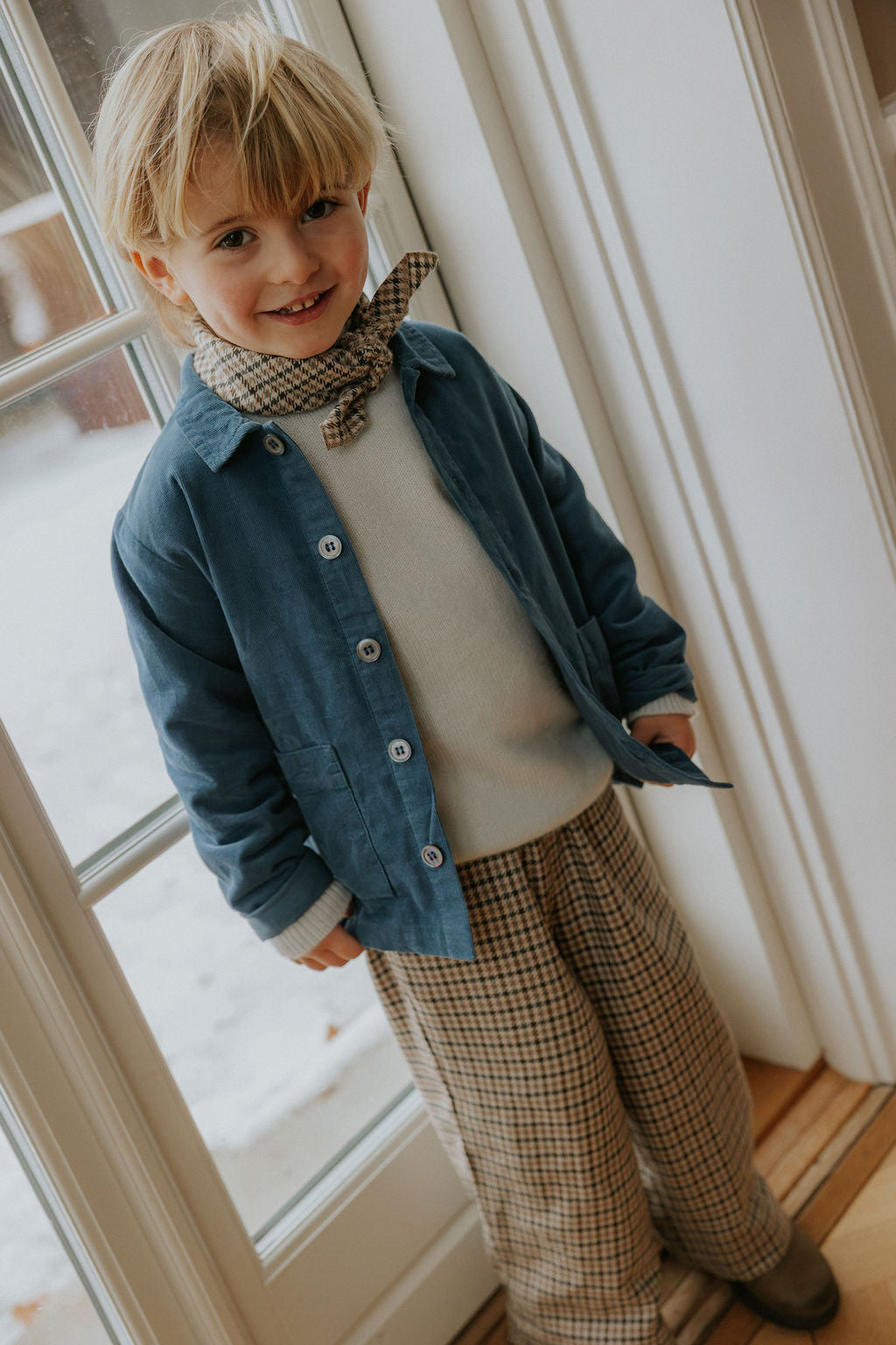 Boy wearing Lalaby Colin jumper in bluey light blue cashmere