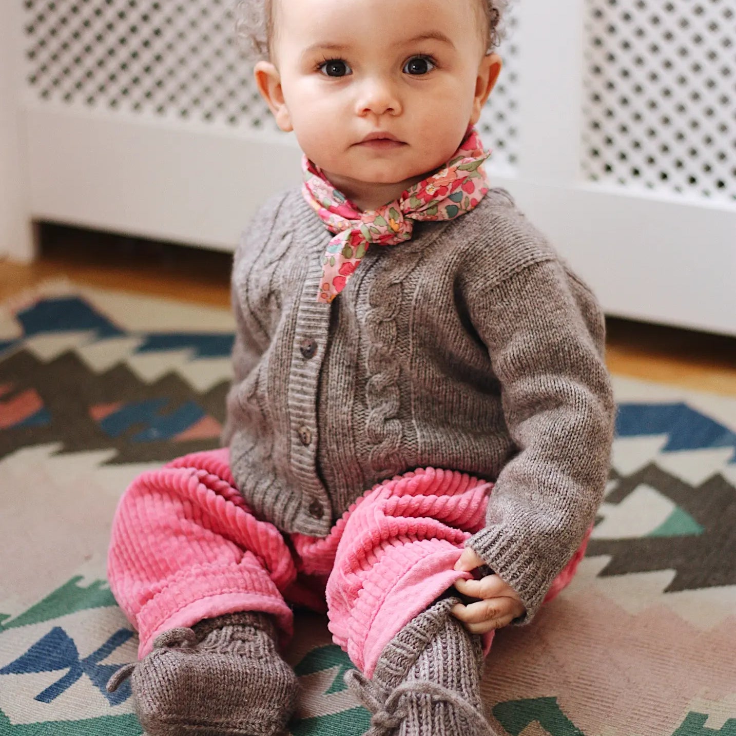 Baby girl wearing Lalaby Cony baby shoes in a millet brown baby wool, yak and cashmere blend