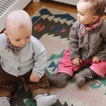 Baby girl wearing Lalaby Cony baby shoes in a millet brown baby wool, yak and cashmere blend