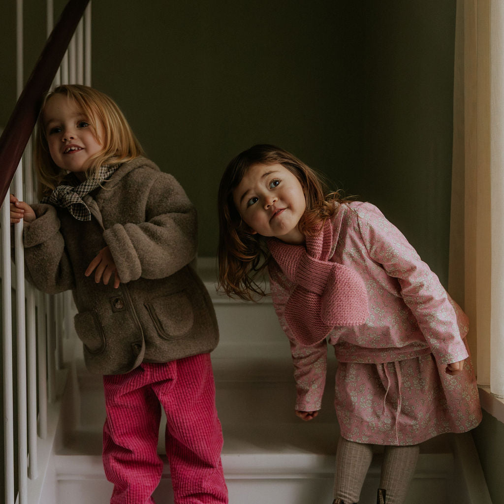 Girl wearing Lalaby Dagmar skirt for kids in pink flower liberty cotton corduroy