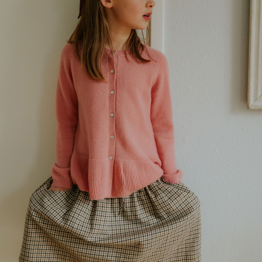 Girl wearing Lalaby Dagmar skirt for kids in tweedy check organic cotton