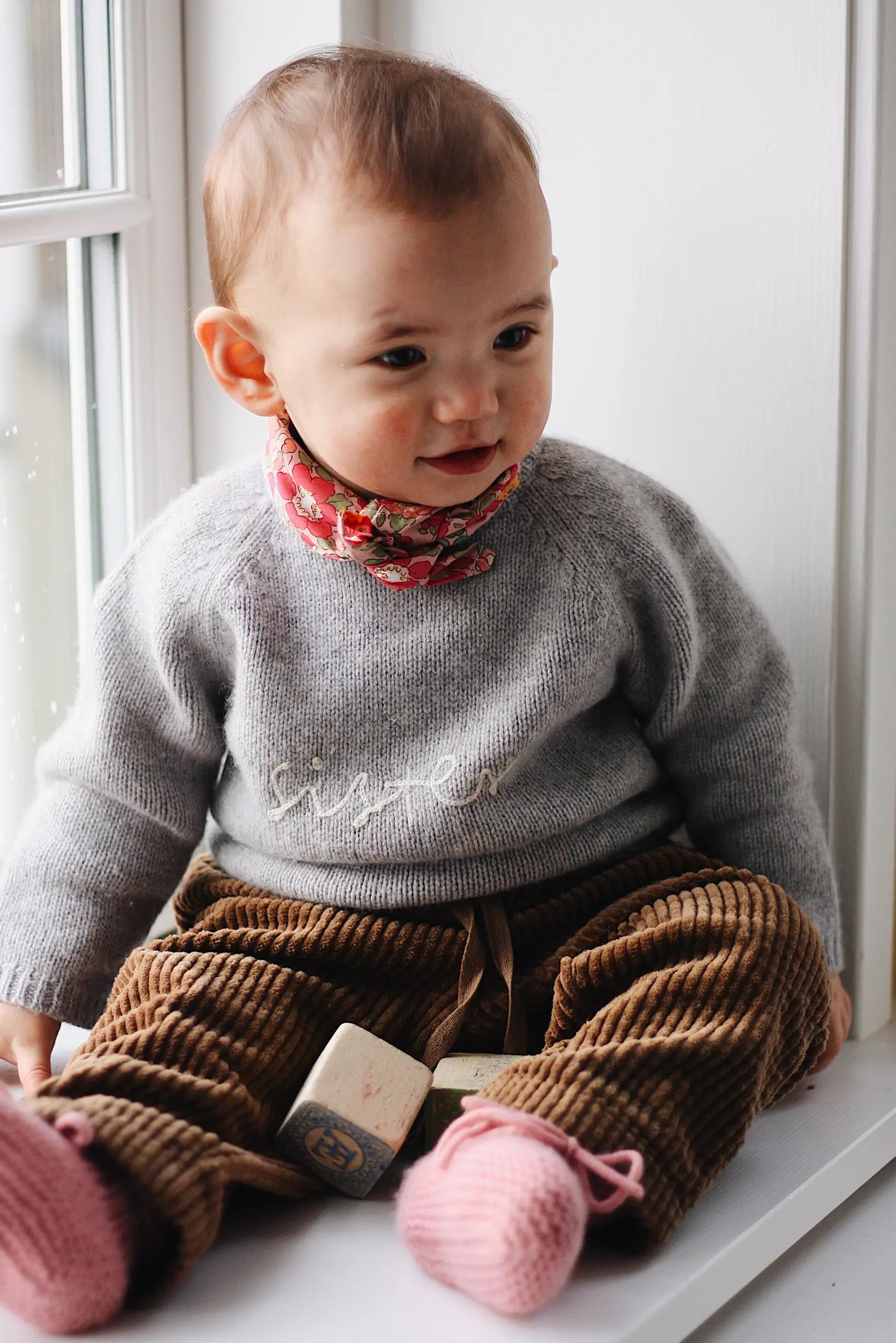 Baby girl wearing Lalaby Eddie scarf for babies and kids in Berry besty pink liberty organic cotton