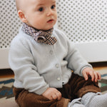 Baby boy wearing Lalaby Eddie scarf for babies and kids in tweedy check organic cotton