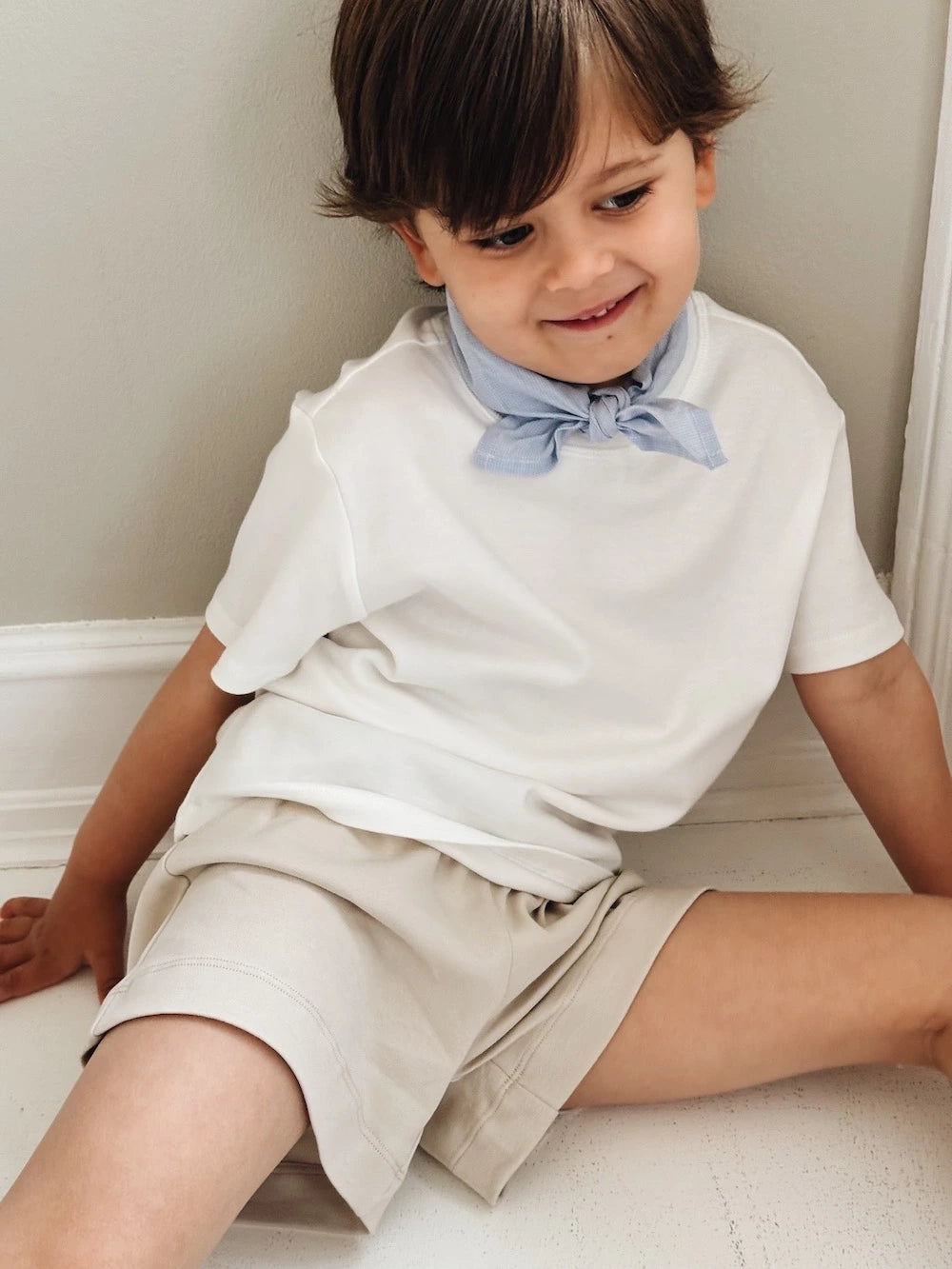 Boy wearing Lalaby eddie scarf for kids and babies in sky blue organic cotton