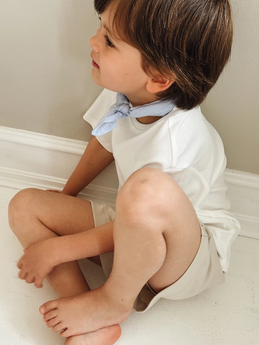 Boy wearing Lalaby eddie scarf for kids and babies in sky blue organic cotton