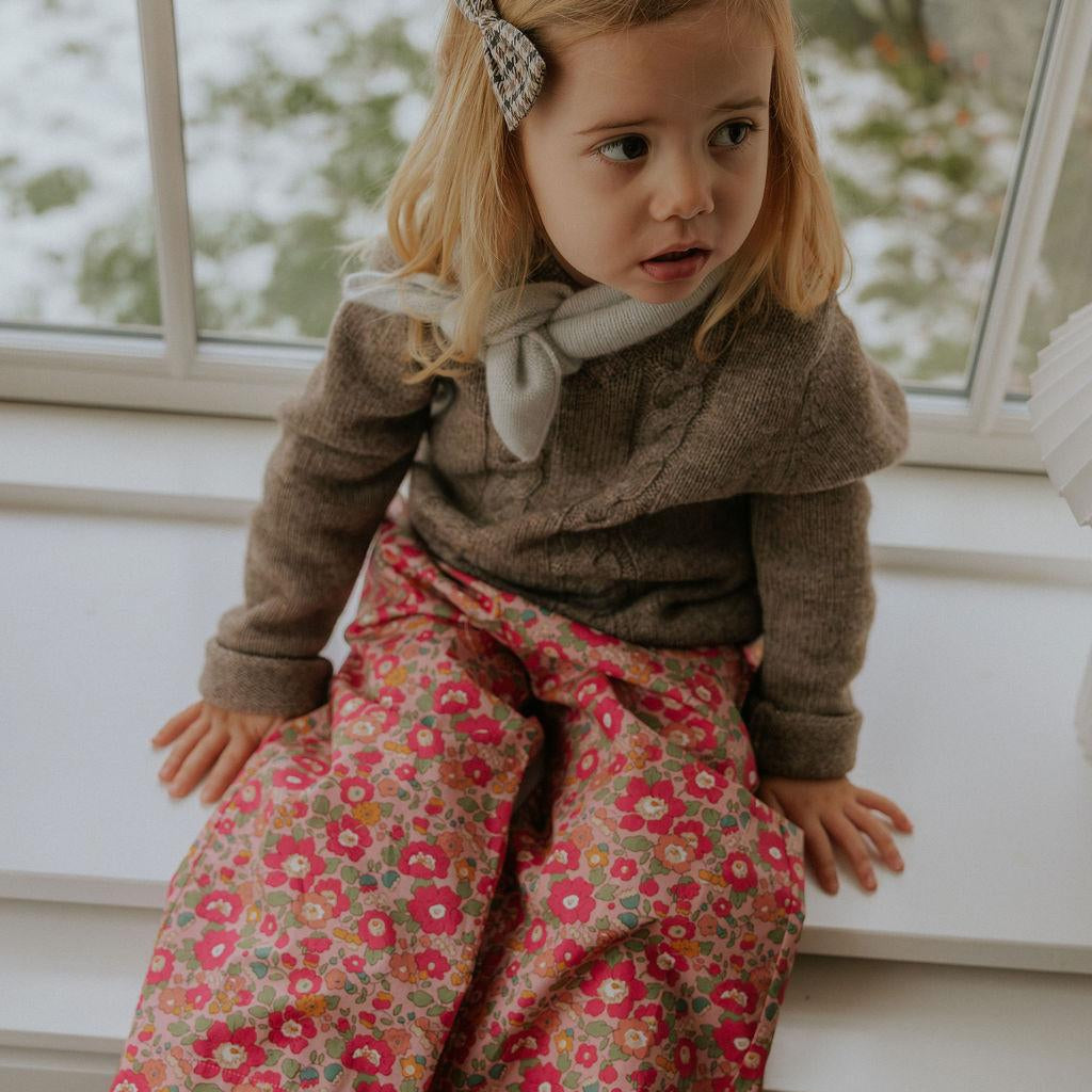 Girl wearing Lalaby Frankie pants for kids in berry betsy pink liberty organic cotton