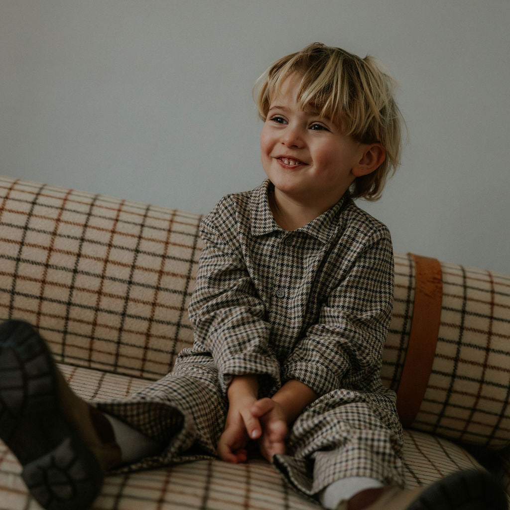 Boy wearing Lalaby Frankie pants for kids in tweedy check organic cotton
