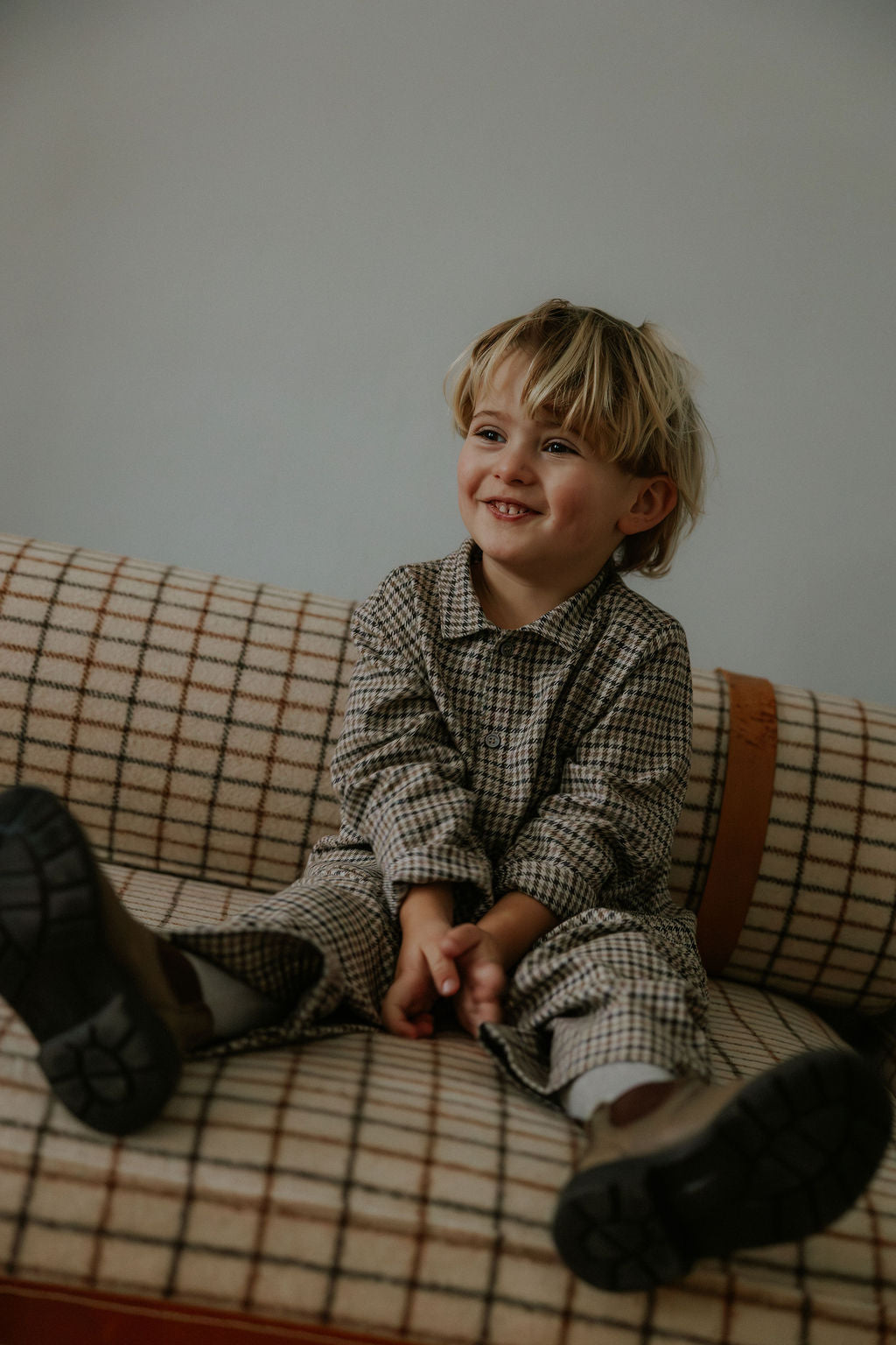 Boy wearing Lalaby Frankie pants for kids in tweedy check organic cotton